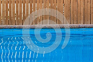 Garden pool site soft focus blue water and wooden fence background outdoor space