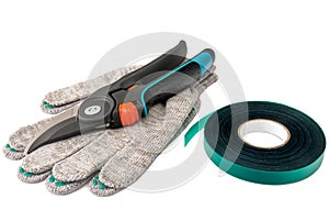 Garden pruning shears with fabric gloves and a band for garters in the garden.