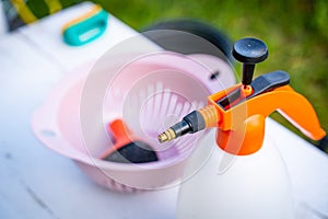 Garden pump sprayer with orange handle close-up. Universal garden sprayer for plant treatment