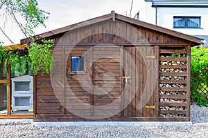 Garden shed exterior in Spring, with woodshed photo