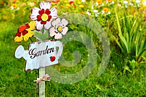Garden sign, message on a wooden watering can