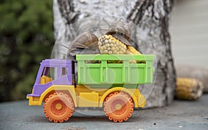 Garden Snails are transporting a corn crop on a multi-colored truck.