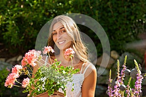 Garden in summer â€“ happy woman with flowers