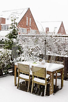 Garden table and chairs under snow