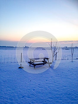 Garden table in snowy sunset in Sweden