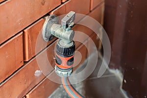 Garden tap with hose attached to it