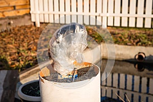 Garden tap wrapped in a plastic bag and disconnected from the water supply before winter