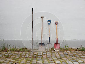 Garden Tools on Cobble Surface with Wall
