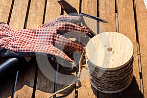 Garden tools with gloves, rake and cord on a table