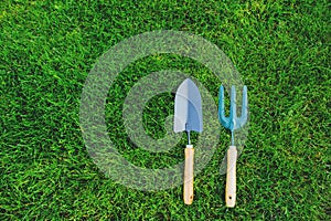 garden tools on green lawn background. Seasonal spring or summer yard work concept