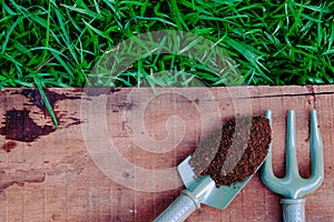 Garden tools and Peat Moss on wooden table top