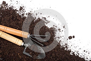 Garden tools in soil isolated on white background with copy space for your text. Top view