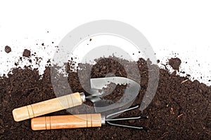 Garden tools in soil isolated on white background with copy space for your text. Top view