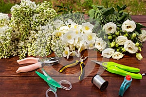 Garden tools, Tools for floristics and flowers on a wooden table. photo