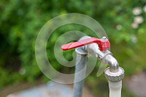 Garden water tap with plastic hose close up shot