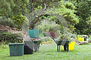 Garden wheelbarrows, buckets and tools for clearing weeds, pruning . photo