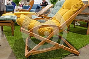 Garden wooden chair with yellow soft cushion photo