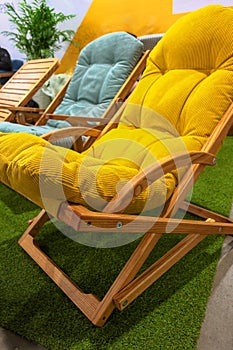 Garden wooden chair with yellow soft cushion photo