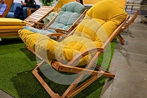 Garden wooden chair with yellow soft cushion photo