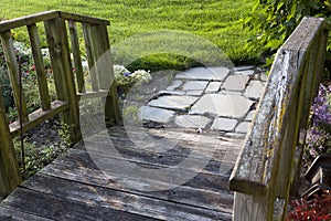 Garden wooden pathway with stone pavers
