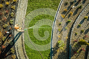 Garden Worker Watering Newly Installed Natural Grass