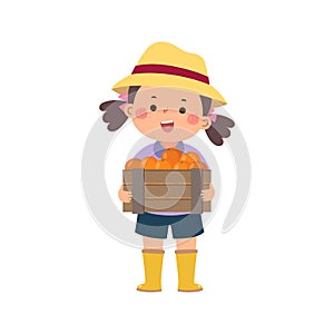 Gardener girl holding wooden box full of fresh oranges