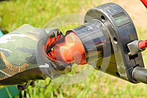 Gardener hand with electric cable and plug connects to the power supply