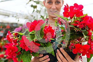 Gardener in her green house flower shop