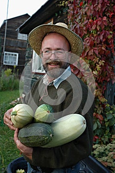 Gardener holding large marrows