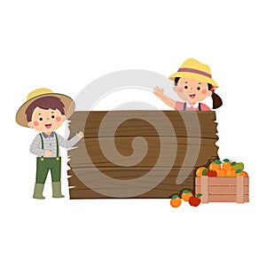 Gardener kids with wooden board and wooden boxes of fruits