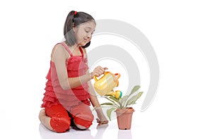Gardener little girl watering plant