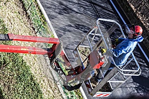 A gardener moves with his tracked basket