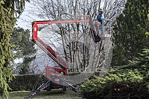 A gardener moves by his tracked basket