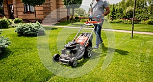 Gardener mowing the lawn. Landscape design. Green background