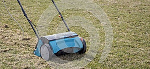 Gardener Operating Soil Aeration Machine on Grass Lawn