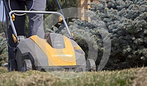 Gardener Operating Soil Aeration Machine on Grass Lawn