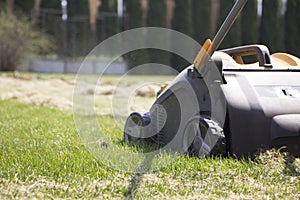 Gardener Operating Soil Aeration Machine on Grass Lawn