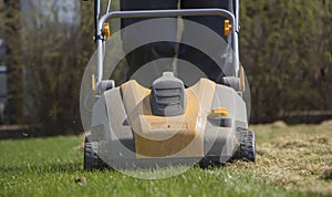 Gardener Operating Soil Aeration Machine on Grass Lawn