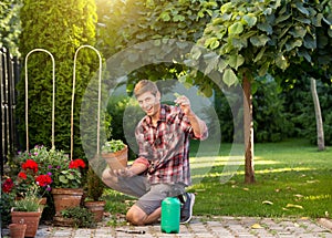 Man taking care of plants in garden photo