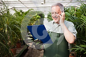 Gardener talking on the phone photo