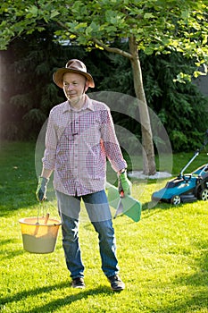 Gardener with tools in backyard