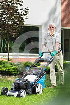 Gardener using a modern lawnmower