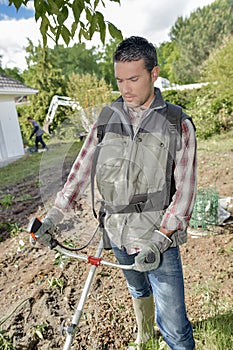 Gardener using a strimmer