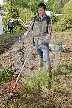 Gardener using a strimmer