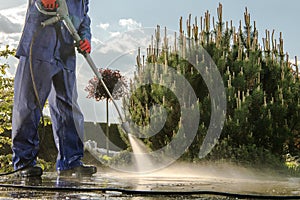 Gardener Washing Garden Paths