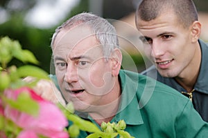 Gardeners talking while gardening at plant nursery photo