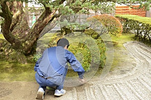 Gardeners working in a garden inside of Ginkaku temple