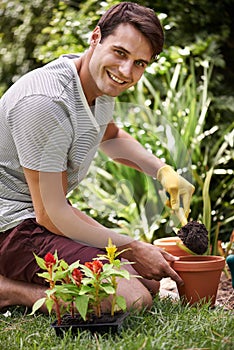 Gardening can be so relaxing. Portrait of a handsome young man gardening outdoors.