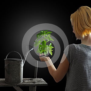 Gardening concept - woman holding a plant