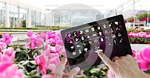 Gardening equipment e-commerce concept, online shopping on digital tablet, hand pointing and touch screen with white tools icons,
